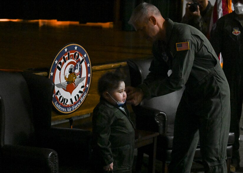 Maj. Gen. Joel Jackson, Air Force District of Washington commander, pins two stars on 8-year-old Elias “Eli” Tadli, during Eli’s visit at Joint Base Andrews, Md. Sept. 1, 2022.