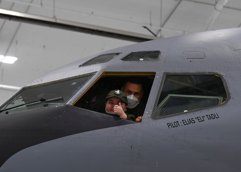 Eight-year-old Eli Tadli, poses out of the window of a KC-135 Stratotanker during his Pilot for a Day visit at Joint Base Andrews, Md. Sept. 1, 2022.