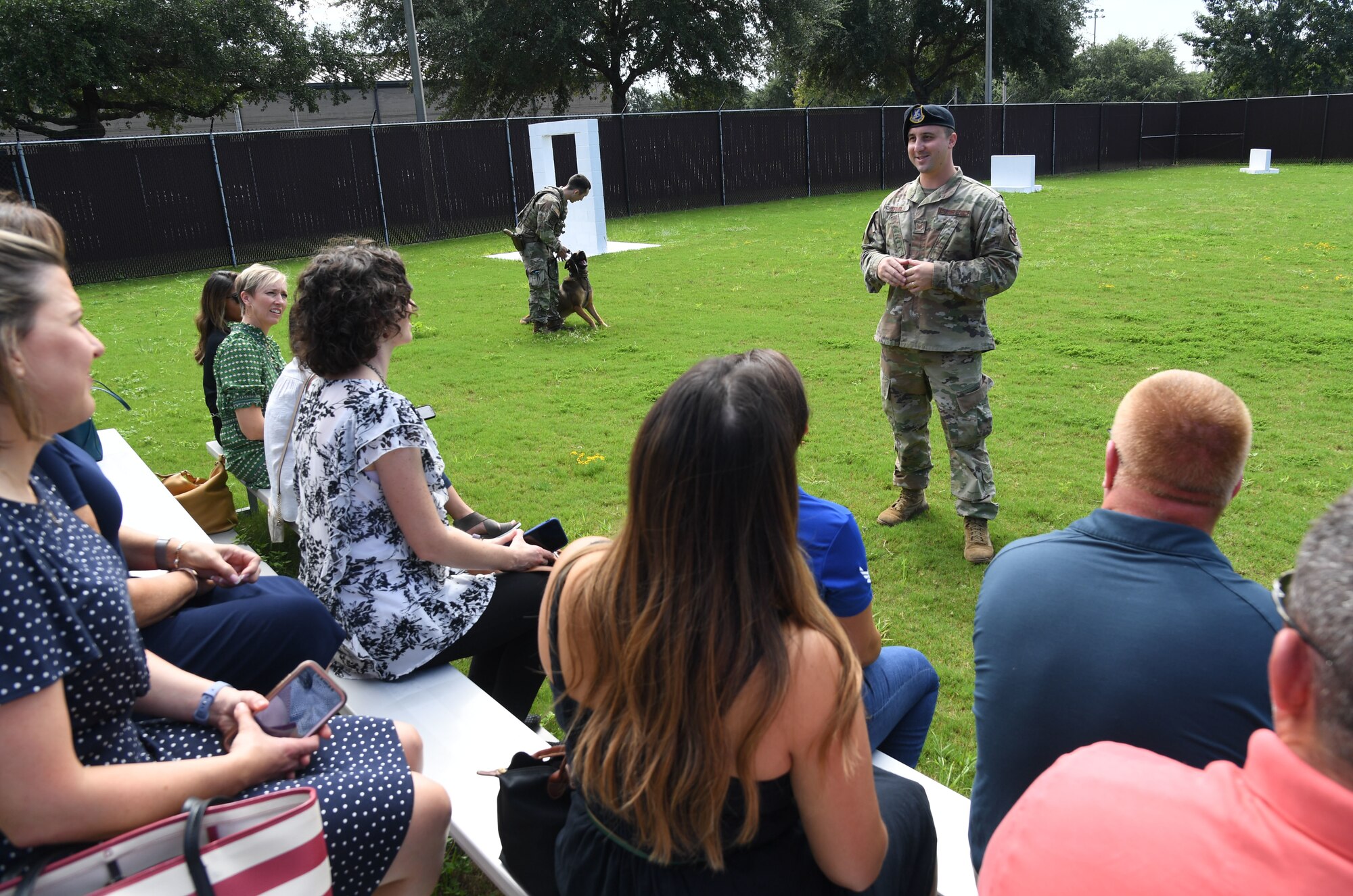 U.S. Air Force Tech. Sgt. Eric Formolo, 81st Security Forces Squadron military working dog kennel master, briefs on the capabilities of the military working dog at Keesler Air Force Base, Mississippi, Aug. 31, 2022. Keesler key spouses and spouses of base leadership also toured a C-130J aircraft, the Keesler Medical Center and the Fisher House. (U.S. Air Force photo by Kemberly Groue)