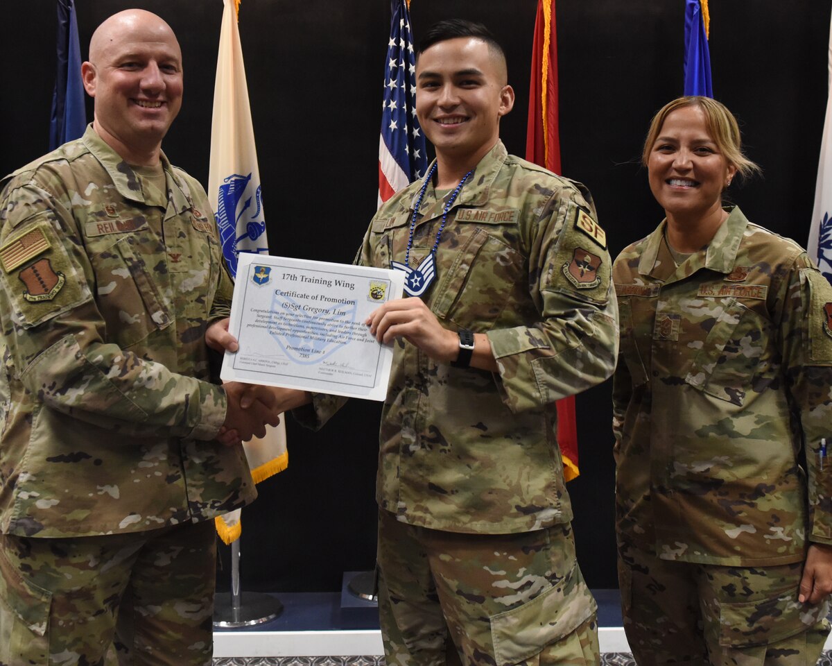 U.S. Air Force Col. Matthew Reilman, 17th Training Wing commander, presents Senior Airman Gregory Lim, 17 Security Forces Squadron patrolman, a promotion certificate during the Staff Sergeant Release Party at Goodfellow Air Force Base, Texas, Sept. 1, 2022. Only 21% of 46,000 Airmen were selected for promotion to the rank of staff sergeant. (U.S. Air Force photo by Airman 1st Class Zachary Heimbuch)