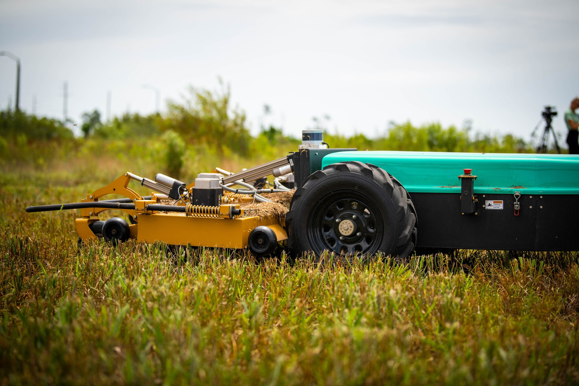 Un-manned lawn mower mows grass.