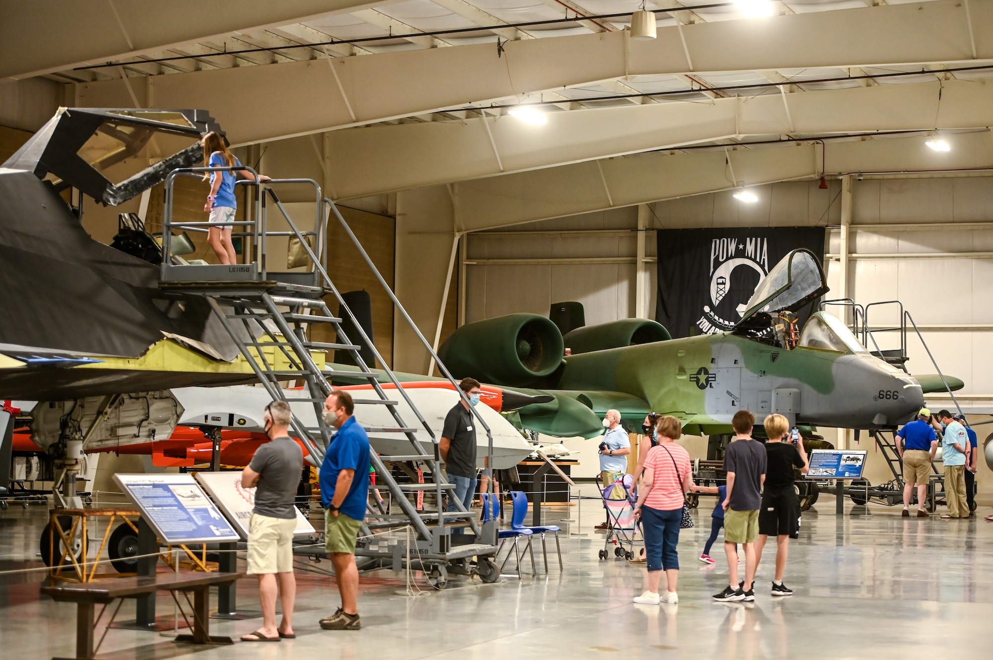 People looking at aircraft inside Hill's Aerospace Museum
