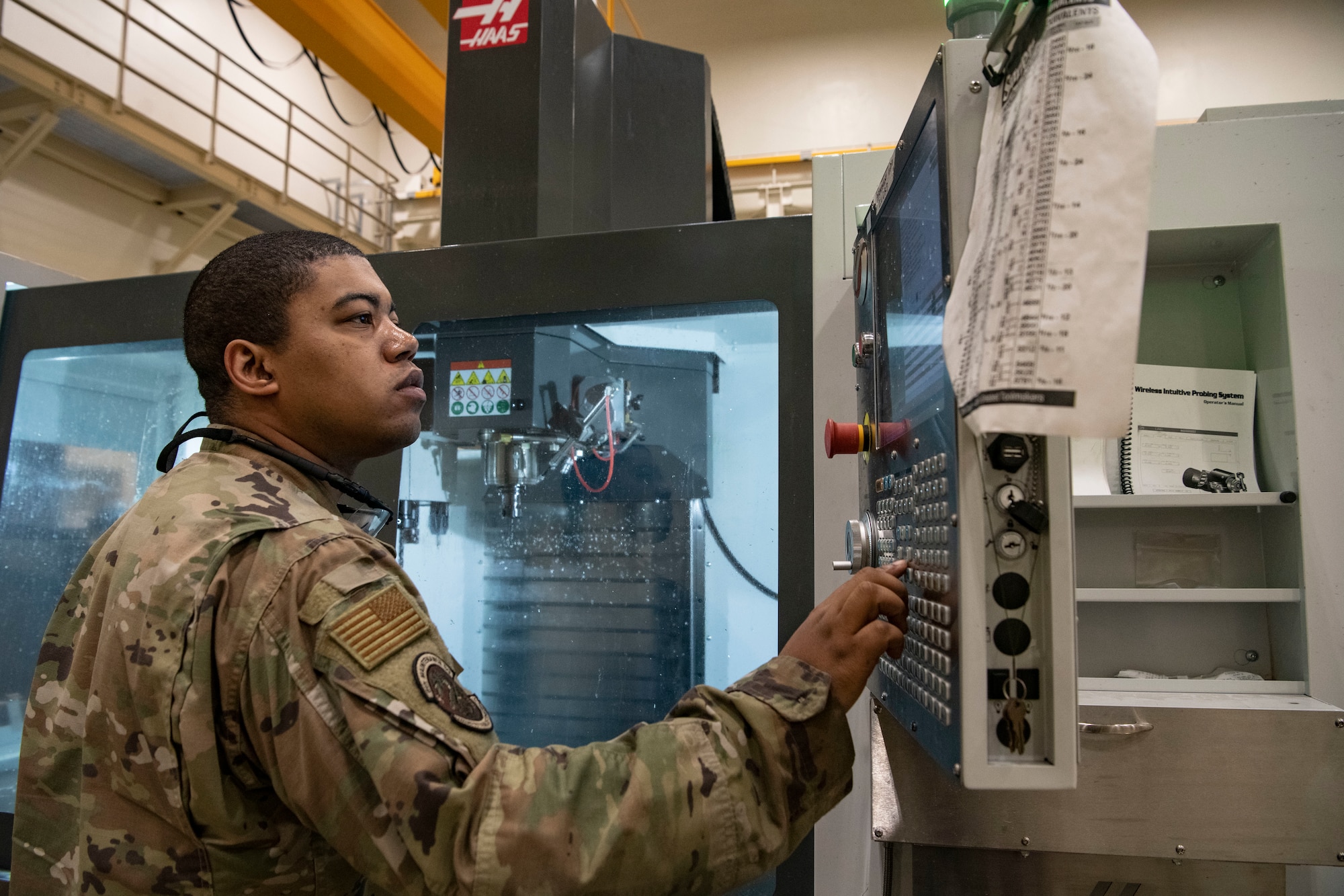 Staff Sgt. Dante Custis, 8th Maintenance Squadron aircraft metals technology craftsman, works a control panel at Kunsan Air Base, Republic of Korea, Aug. 26, 2022. The flight can use computer-aided design programs to create 3-D models that are transport them into various fabrication machines and create needed parts for their customers. (U.S. Air Force photo by Staff Sgt. Sadie Colbert)