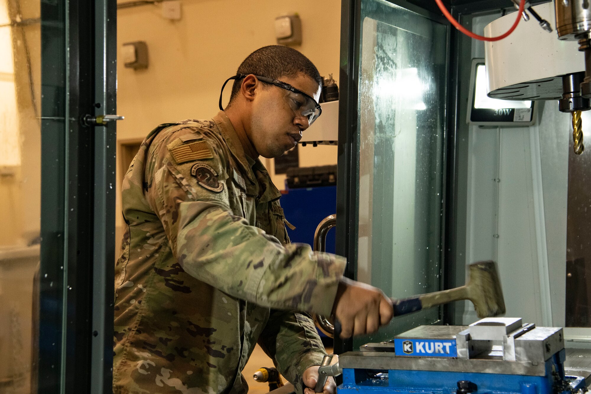 Staff Sgt. Dante Custis, 8th Maintenance Squadron aircraft metals technology craftsman, seats a slab of metal at Kunsan Air Base, Republic of Korea, Aug. 26, 2022. The flight customizes their fabrication machines with different tools to ensure precise cuts and the desired quality of each piece. (U.S. Air Force photo by Staff Sgt. Sadie Colbert)
