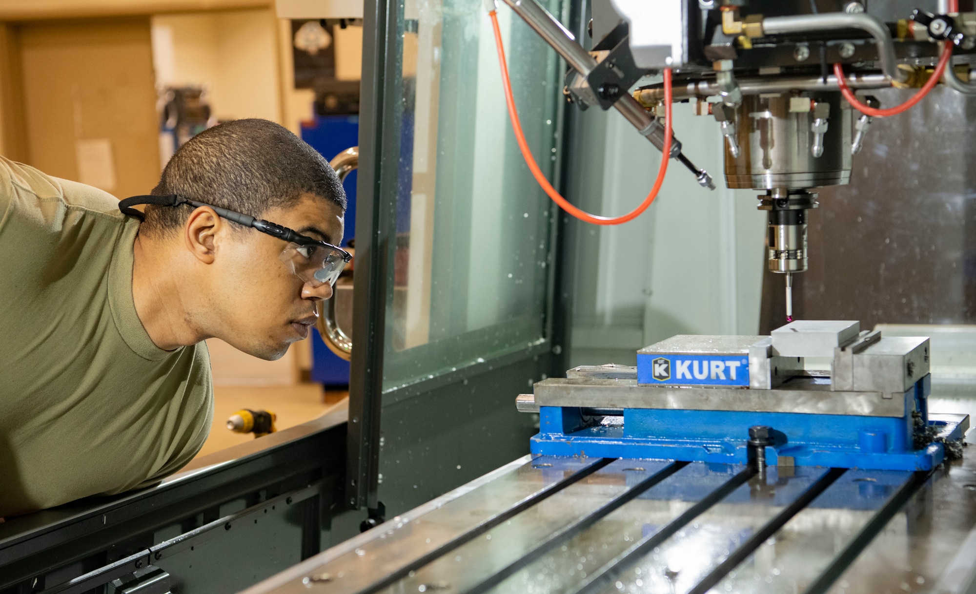Staff Sgt. Dante Custis, 8th Maintenance Squadron aircraft metals technology craftsman, inspects a fabrication probe at Kunsan Air Base, Republic of Korea, Aug. 26, 2022. The probe measures the size of the metal slab and sends the measurement into the machine to ensure an accurate scaled cut. (U.S. Air Force photo by Staff Sgt. Sadie Colbert)