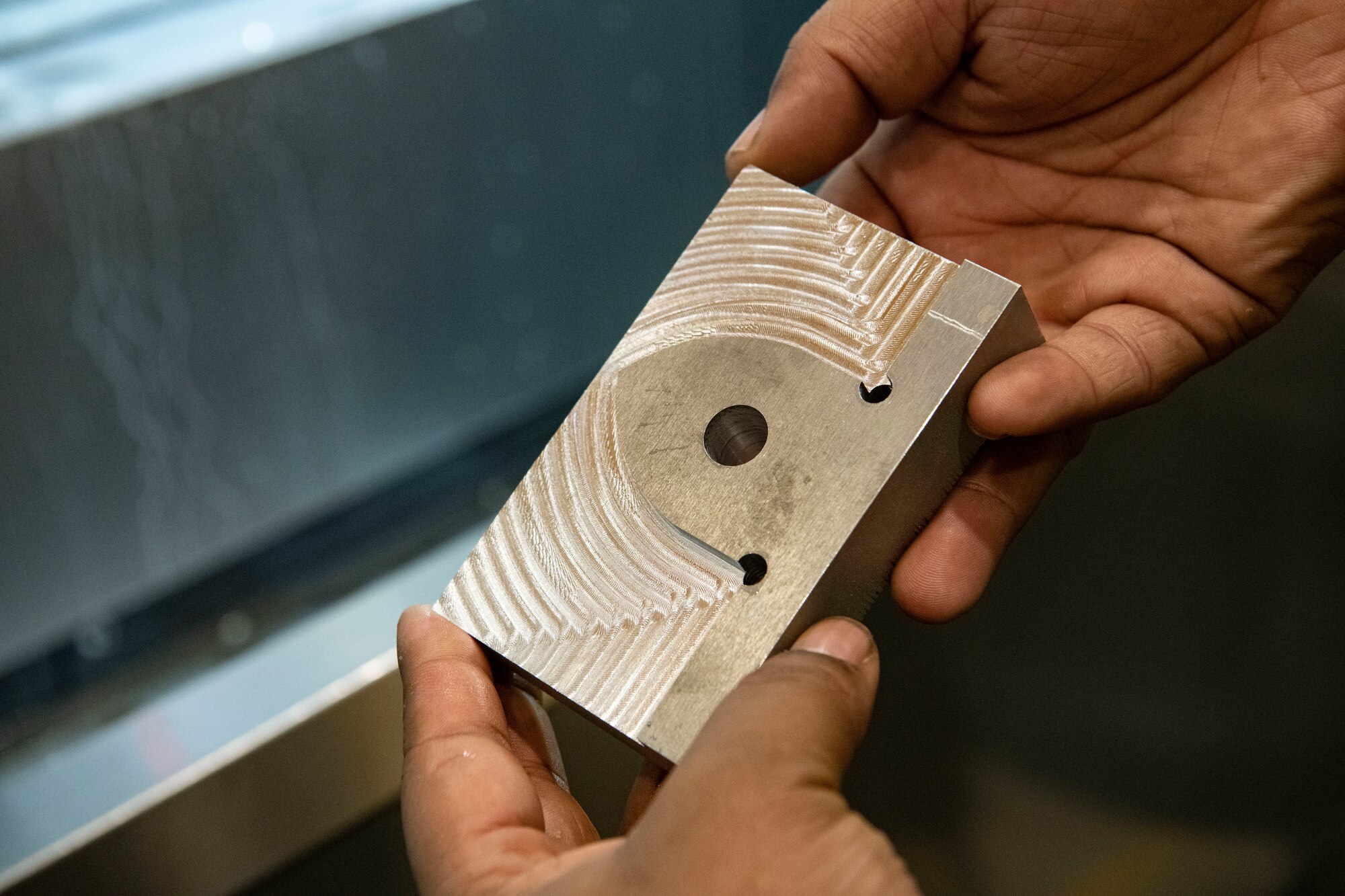 Staff Sgt. Dante Custis, 8th Maintenance Squadron aircraft metals technology craftsman, inspects a newly cut metal part at Kunsan Air Base, Republic of Korea, Aug. 26, 2022. Whereas most careers involved in fabrication are split between machinists, welders and programmers, the metals technology Airmen can run all three positions, giving them flexibility to quickly accomplish their tasks. (U.S. Air Force photo by Staff Sgt. Sadie Colbert)