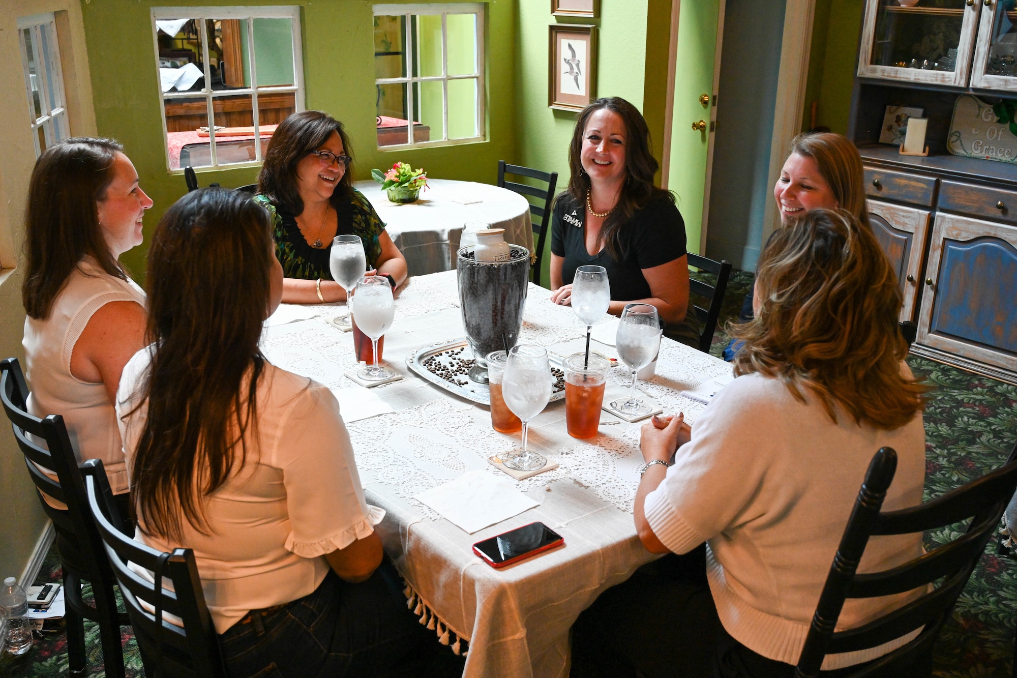 Maureen Robinson, spouse of Lt. Gen. Brian Robinson, commander of Air Education and Training Command, laughs with key spouses from the 97th Air Mobility Wing at Altus, Oklahoma, Aug. 31, 2022. Robinson visited different areas on and off the base that support the quality of life for Airmen and their families, including the 97th Medical Group, Child Development Center, base housing, Airman dormitories and the military spouse co-working space. (U.S. Air Force photo by Airman 1st Class Trenton Jancze)