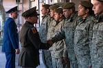U.S. Army Maj. Gen. Francis Evon, left foreground, the Connecticut adjutant general, shakes hands with a Uruguayan Army soldier during a visit to the National Peace Operations Training School of Uruguay, Montevideo, Uruguay, Aug. 10, 2022. The school is where Uruguayan military and police forces train to prepare to deploy in support of U.N. peacekeeping operations.
