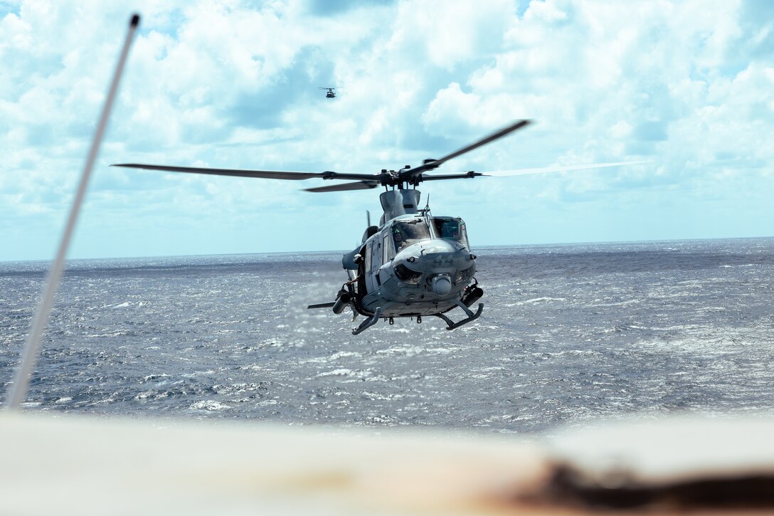 Two U.S. Marine Corps UH-1Y Venom  helicopters assigned to Light Attack Helicopter Squadron (HMLA) 773 prepare to land aboard the San Antonio class dock landing ship USS Mesa Verde (LPD 19) in the North Atlantic Ocean, Aug. 16, 2022. HMLA 773 launched three UH-1Y Venom and two AH-1Z Viper helicopters from McGuire Air Force Base and embarked them aboard the USS Mesa Verde for transit to Brazil in support of exercise UNITAS LXIII hosted by the Brazilian Navy and Marine Corps. UNITAS, which is Latin for “unity,” was conceived in 1959 and has taken place annually since first conducted in 1960. This year marks the 63rd iteration of the world’s longest-running annual multinational maritime exercise. Additionally, this year Brazil will celebrate its bicentennial, a historical milestone commemorating 200 years of the country’s independence. (U.S. Marine Corps photo by Cpl. Colton K. Garrett)