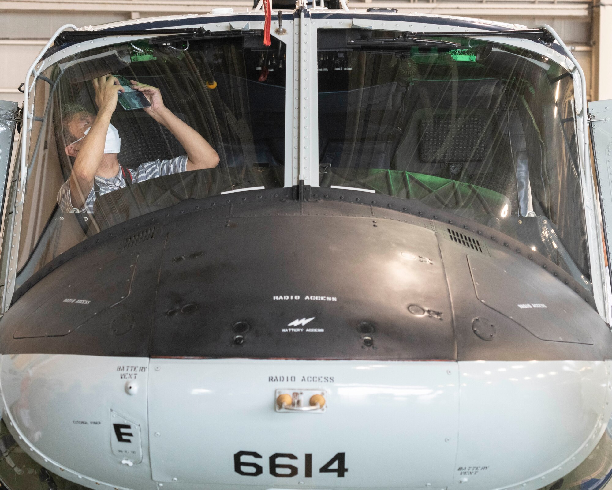 An aviation enthusiast takes a photo of the cockpit of a UH-1N Iroquois during a tour at Yokota Air Base, Japan, Aug. 31, 2022.