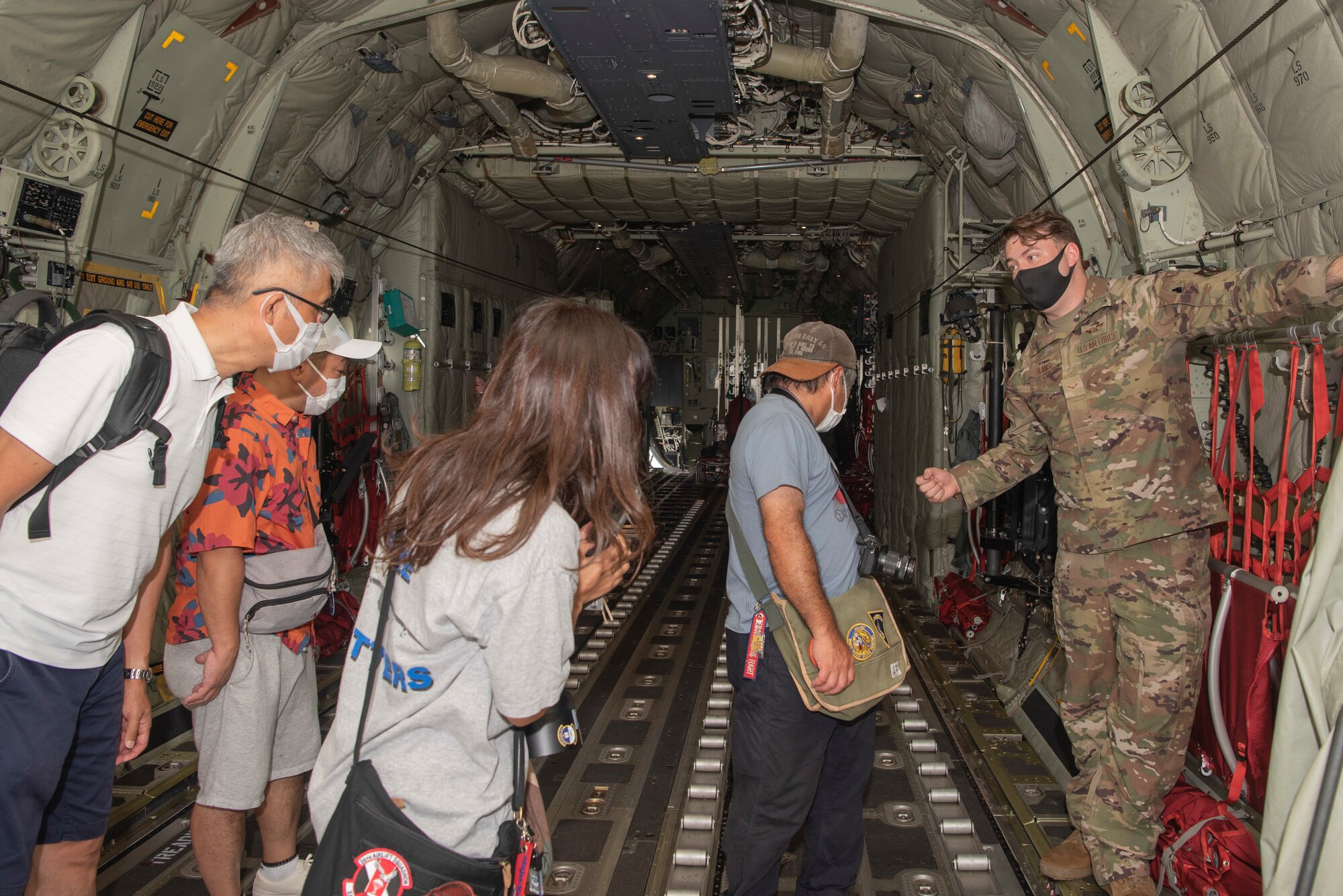 Airman 1st Class Spencer Kans, 36th Airlift Squadron loadmaster, explains the C-130J Super Hercules capabilities during a tour at Yokota Air Base, Japan, Aug. 31, 2022