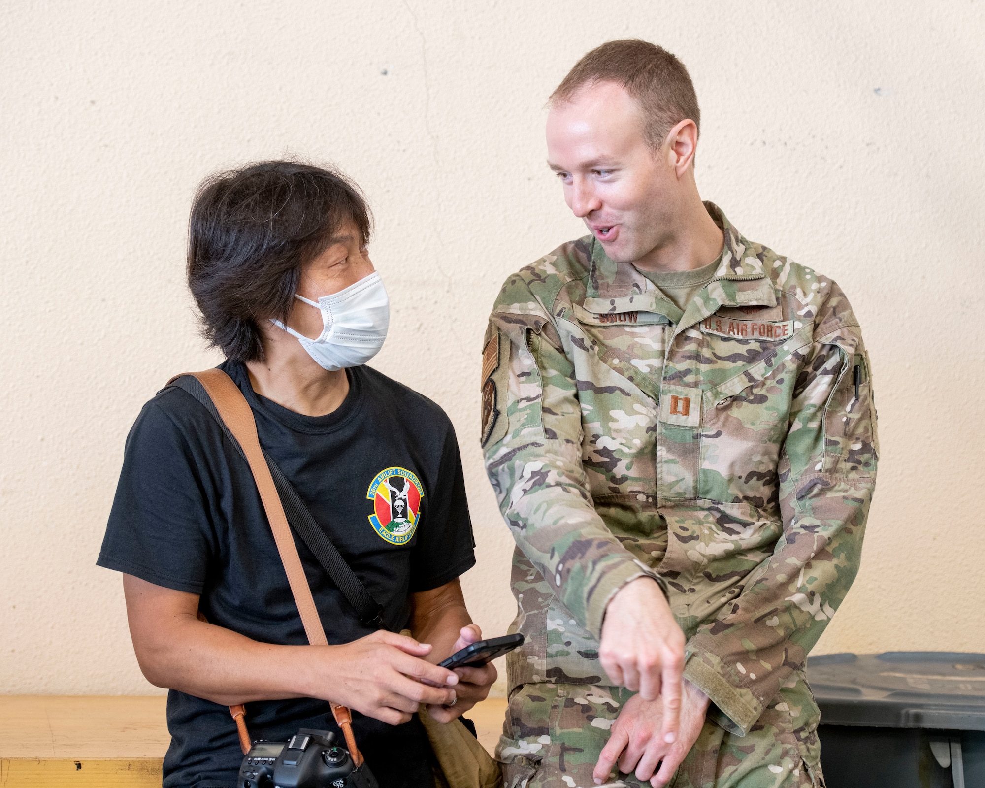 Capt. Spencer Snow, 459th Airlift Squadron UH-1N pilot, speaks with a Japanese aviation enthusiast during a tour at Yokota Air Base, Japan, Aug. 31, 2022.