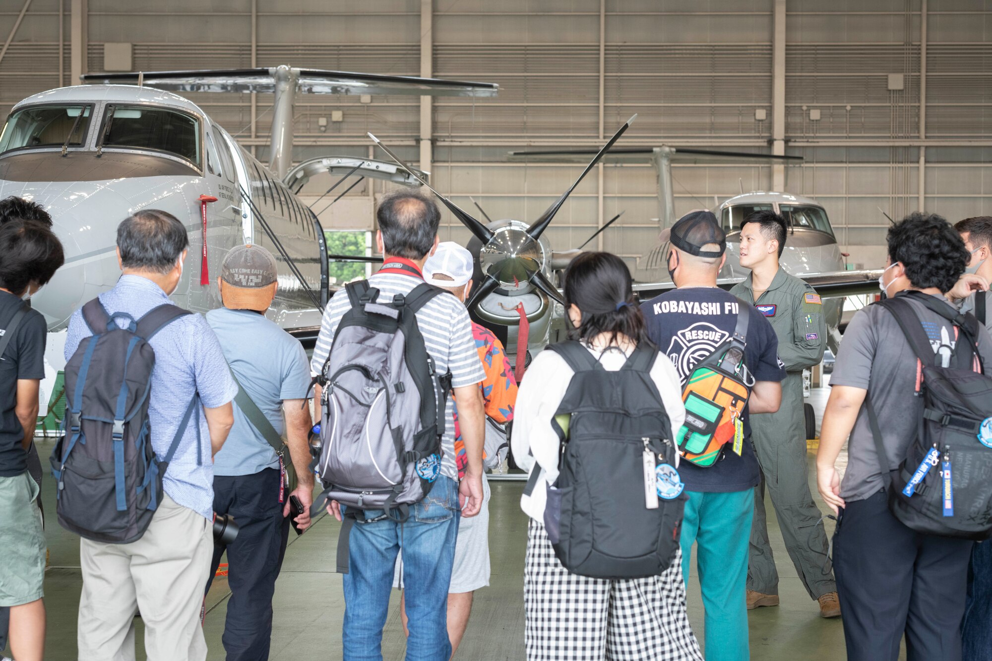 Capt. John Lu, 459th Airlift Squadron C-12J instructor pilot, gives a C-12J Huron briefing during a tour at Yokota Air Base, Japan, Aug. 31, 2022.