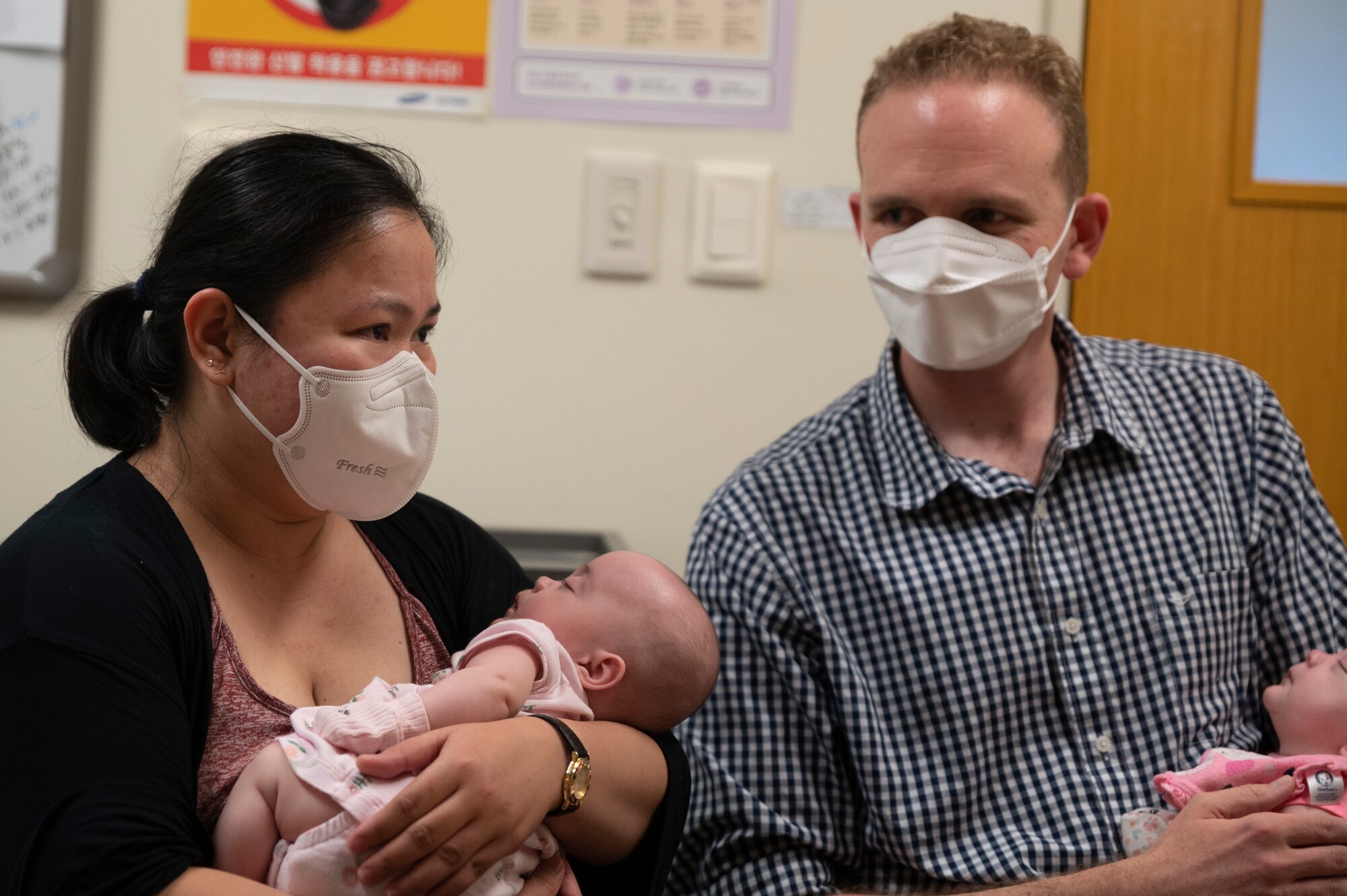 TSgt Ross Malcolm, 51st Operations Support Squadron radar technician, and his wife Ann Malcolm hold two of their triplets discharged from the Neonatal Intensive Care Unit (NICU) during their release celebration at the Samsung Seoul Hospital, Republic of Korea.