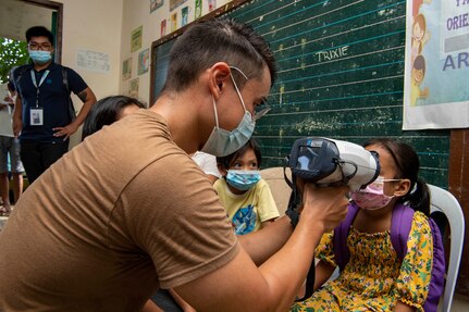 PUERTO PRINCESA, Philippines (Aug. 12, 2022) – Hospital Corpsman 3rd Class Anthony Temm, from Riverside, California, left, checks the vision of local community members during the Barangay Health Fair at Bacungan High School during Pacific Partnership 2022. Now in its 17th year, Pacific Partnership is the largest annual multinational humanitarian assistance and disaster relief preparedness mission conducted in the Indo-Pacific. (U.S. Navy photo by Mass Communication Specialist 2nd Class Brandie Nuzzi)