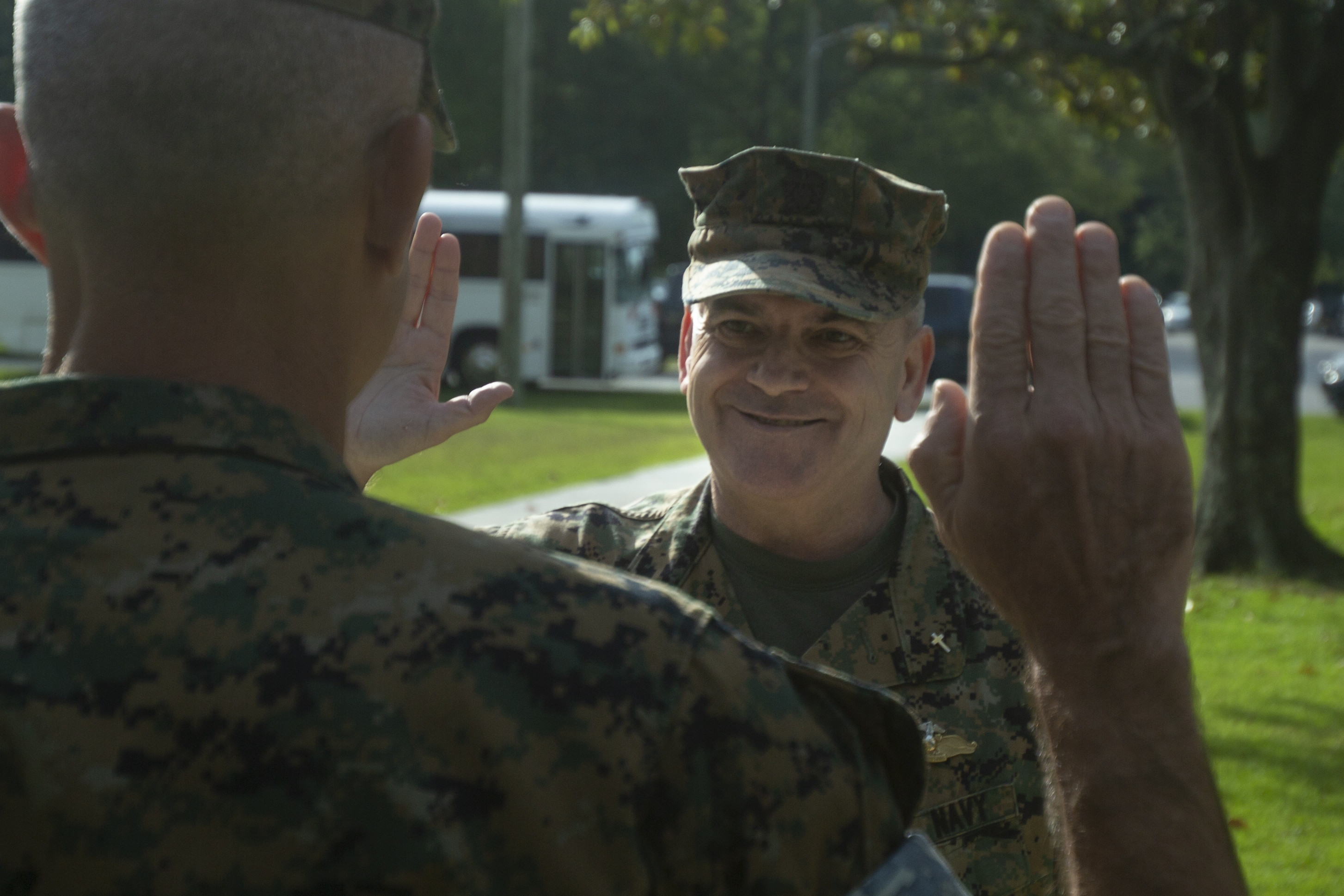 Two Marines facing each other taking an oath, both with their right hand up.