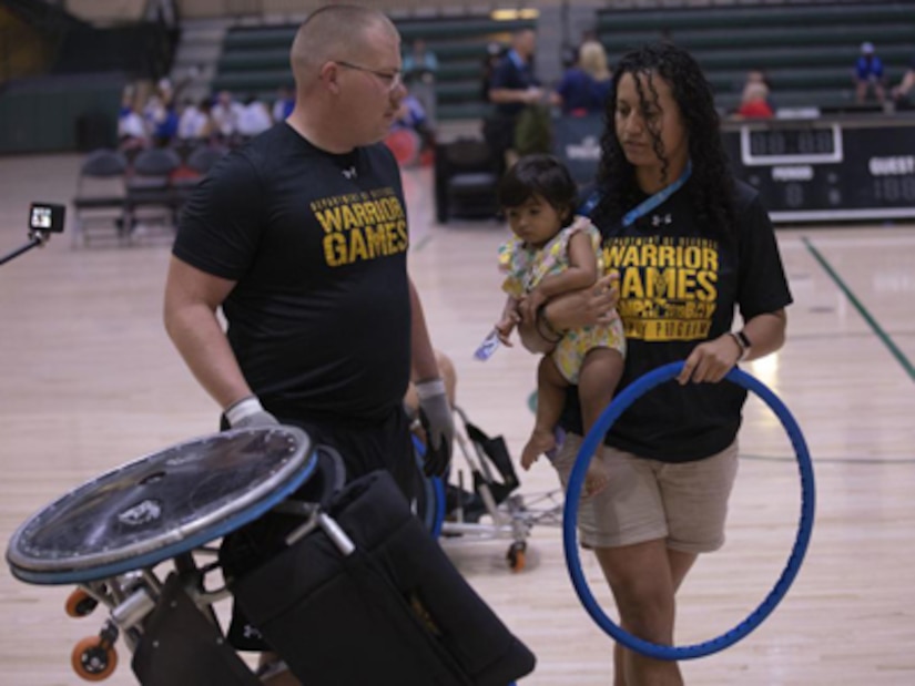 U.S. Army Staff Sgt. Cole Thielen, left, and Liannie Rodriguez work on repairing the wheelchair rugby wheel at the ESPN Wide World of Sports Complex in Orlando, Florida, Aug. 18, 2022. Hosted by the U.S. Army at the Walt Disney World Resort, this year’s Warrior Games sees service members and veterans from across the DoD competing in a variety of adaptive sports alongside armed forces athletes from Canada and Ukraine.