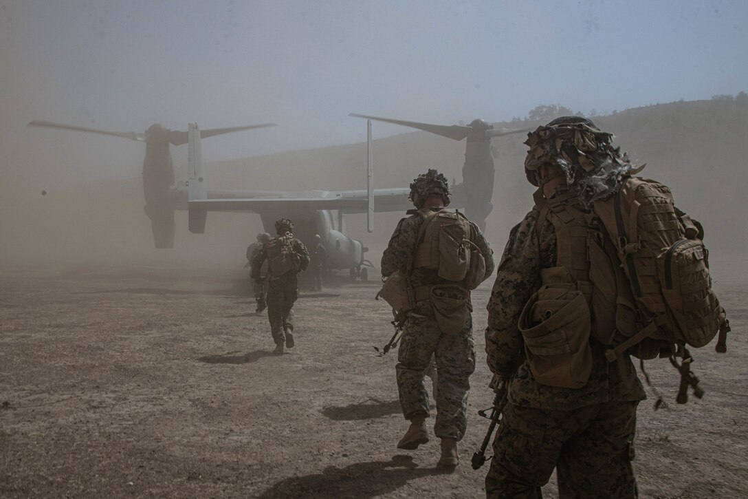 U.S. Marines with Weapons Company, 1st Battalion, 4th Marine Regiment, 1st Marine Division, board an MV-22B Osprey during a Tactical Recovery of Aircraft and Personnel exercise at Marine Corps Base Camp Pendleton, California, Aug. 23, 2022. This training evolution tested the Marines' ability to provide timely aid to isolated personnel in potential search and rescue situations. (U.S. Marine Corps photo by Cpl. Harris)