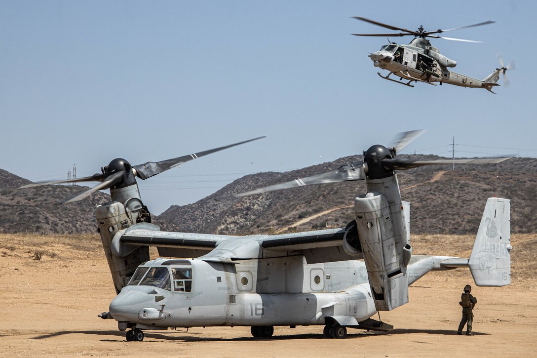 A U.S. Marine Corps MV-22B Osprey with Marine Medium Tiltrotor Squadron 364 and a UH-1Y Venom with Marine Light Attack Helicopter Squadron 169, take part in a Tactical Recovery of Aircraft and Personnel exercise with 1st Battalion, 4th Marine Regiment, 1st Marine Division, at Marine Corps Base Camp Pendleton, California, Aug. 23, 2022. This training evolution tested the Marines' ability to provide timely aid to isolated personnel in potential search and rescue situations.  (U.S. Marine Corps photo by Cpl. Harris)
