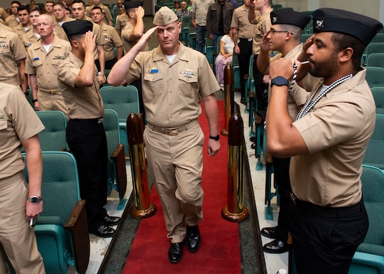 Cmdr. Bill Howey, the final commanding officer of the Los Angeles-class fast-attack submarine USS Providence (SSN 719), passes through sideboys during a decommissioning ceremony for the submarine, Sept. 1, 2022