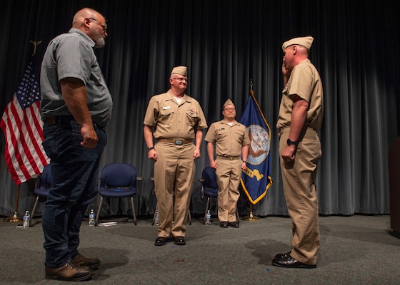 Cmdr. Bill Howey, right, the final commanding officer of the Los Angeles-class fast-attack submarine USS Providence (SSN 719), salutes Capt. Shawn Huey, commander, Submarine Squadron 19, after transferring command of the boat to the shipyard during a decommissioning ceremony for the submarine, Sept. 1, 2022.