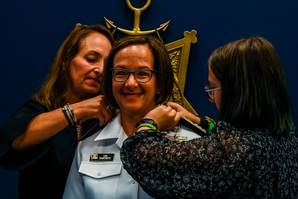 WASHINGTON (Sept. 2, 2022) – Adm. Lisa Franchetti gets her 4-star shoulder boards attached by her family, during her promotion and change of office ceremony held at the Pentagon, Sept. 2. Franchetti was sworn in as the 42nd Vice Chief of Naval Operations when she assumed duties from Adm. William Lescher during the ceremony. (U.S. Navy photo by Mass Communication Specialist 1st Class Michael B. Zingaro/released)