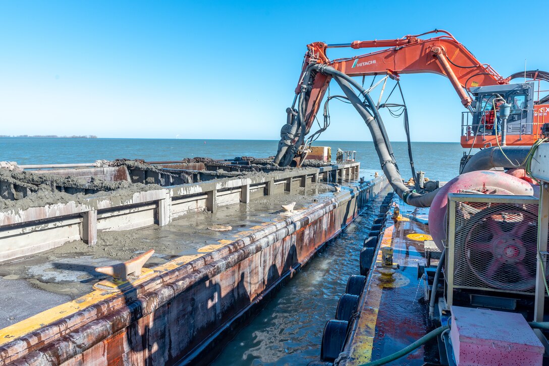 U.S. Army Corps of Engineers (USACE) Buffalo District contractor Ryba Marine Construction Co. pumps out dredged material from a scow in Toledo Harbor.