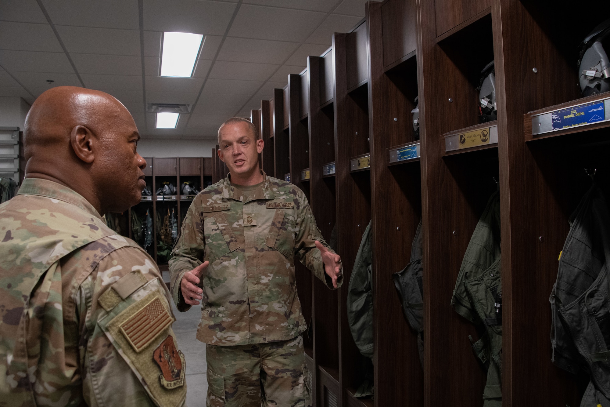 U.S. Air Force Senior Master Sgt. Joshua Buckholtz, 131st Operational Support Squadron aircrew flight equipment (AFE) superintendent, explains how the professionalism of AFE Airmen is a force multiplier for B-2 operations to U.S. Air Force Senior Enlisted Advisor Tony L. Whitehead, the senior enlisted advisor to the chief of the National Guard Bureau at Whiteman Air Force Base, Missouri, Aug. 30, 2022. Whitehead visited the base to learn how National Guard Soldiers and Airmen contribute to state and national mission success. (U.S. Air National Guard photo by Airman 1st Class Phoenix Lietch)