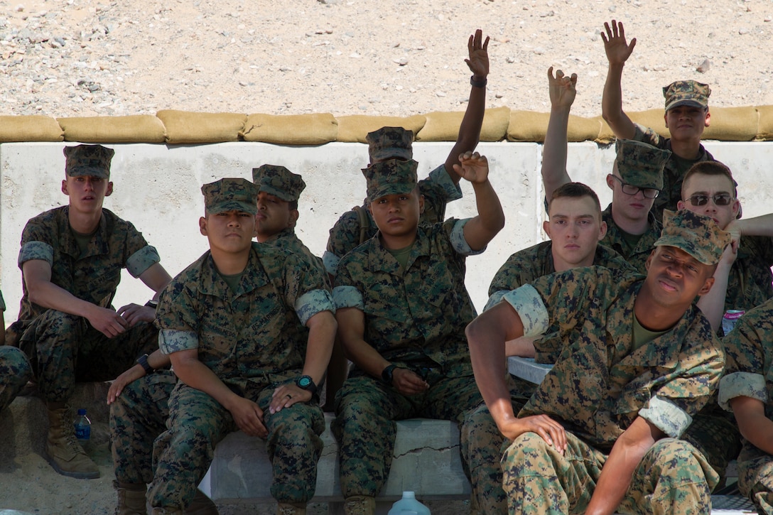 U.S. Marines, students from Marine Corps Communication-Electronics School, raise their hands during a legal assistance brief at Marine Corps Air Ground Combat Center, Twentynine Palms, California, April 13, 2022. Legal Services Support Team 29 Palms met with the students for a weekly brief on available legal assistance services to ensure they step off on the right foot towards a successful military career. (U.S. Marine Corps photo by Lance Cpl. Jacquilyn Davis)