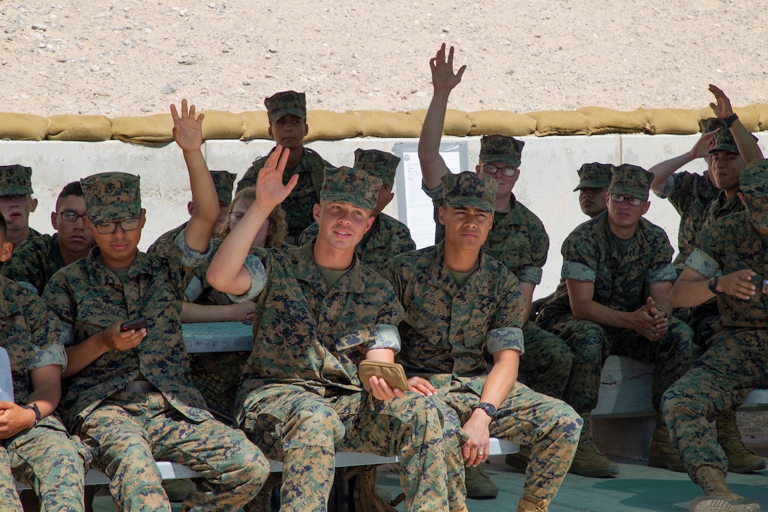 U.S. Marines, students from Marine Corps Communication-Electronics School, raise their hands during a legal assistance brief at Marine Corps Air Ground Combat Center, Twentynine Palms, California, April 13, 2022. Legal Services Support Team 29 Palms met with the students for a weekly brief on available legal assistance services to ensure they step off on the right foot towards a successful military career. (U.S. Marine Corps photo by Lance Cpl. Jacquilyn Davis)