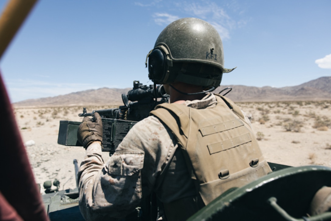 U.S. Marine Corps Lance Cpl. Elijah Wasson, a light armored vehicle (LAV) commander with 3rd Light Armored Reconnaissance (LAR) Battalion, 1st Marine Division, prepares to engage targets with an M240B machine gun from the top of an LAV during live-fire training at Marine Corps Air Ground Combat Center, Twentynine Palms, California, Aug. 12, 2022. The Marines conducted LAV intermediate gunnery training for LAV crew qualifications. (U.S. Marine Corps photo by Lance Cpl. Andrew Bray)