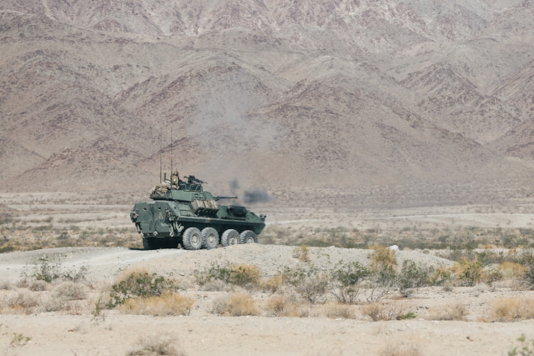U.S. Marines with 3rd Light Armored Reconnaissance Battalion (LAR), 1st Marine Division, fire an M242 Bushmaster 25mm chain gun from a light armored vehicle (LAV) during a live-fire exercise at Marine Corps Air Ground Combat Center, Twentynine Palms, California, Aug. 11, 2022. The Marines conducted LAV intermediate gunnery training for LAV crew qualifications. (U.S. Marine Corps photo by Lance Cpl. Andrew Bray)