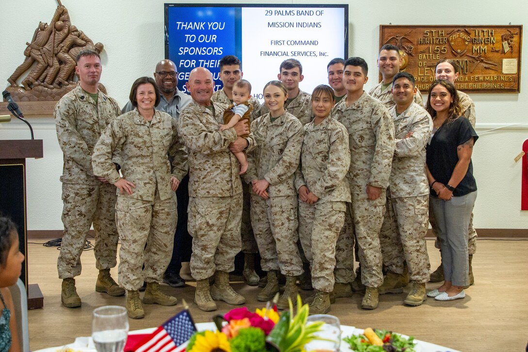 U.S. Marines and families pose for a photo during a Service Members of the Quarter Honoree Luncheon at Marine Corps Air Ground Combat Center, Twentynine Palms, California, Aug. 31, 2022. The Armed Services YMCA hosted the luncheon to congratulate the honorees on their outstanding service. (U.S. Marine Corps photo by Lance Cpl. Jacquilyn Davis)