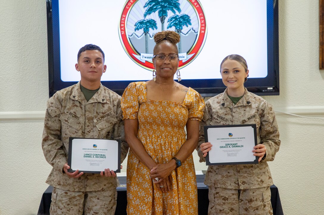 U.S. Marine Corps Lance Cpl. Daniel Recinos (Left), an admin clerk with Headquarters Battalion, Karmolette O’Gilvie (Center), Mayor of Twentynine Palms, and Sgt. Grace Grimaldi, platoon sergeant with Exercise Support Division, pose for a photo during the Service Members of the Quarter Honoree Luncheon at Marine Corps Air Ground Combat Center, Twentynine Palms, California, Aug. 31, 2022. The Armed Services YMCA hosted the luncheon to congratulate the honorees on their outstanding service. (U.S. Marine Corps photo by Lance Cpl. Jacquilyn Davis)