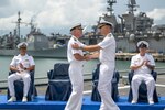 Capt. Tim LaBenz, right, relieves Capt. Tom Ogden as commodore of Destroyer Squadron (DESRON) 7 during the change of command ceremony aboard the Independence-variant littoral combat ship USS Charleston (LCS 18) in Singapore, Sept. 2, 2022. Charleston, part of DESRON 7, is on a rotational deployment, operating in the U.S. 7th Fleet area of operations to enhance interoperability with partners and serve as a ready-response force in support of a free and open Indo-Pacific region. As the U.S. Navy’s destroyer squadron forward-deployed in Southeast Asia, DESRON 7 serves as the primary tactical and operational commander of littoral combat ships rotationally deployed to Singapore, Expeditionary Strike Group (ESG) 7’s Sea Combat Commander, and builds partnerships through training exercises and military-to-military engagements. U.S. Coast Guard photo by Aux. David Lau)