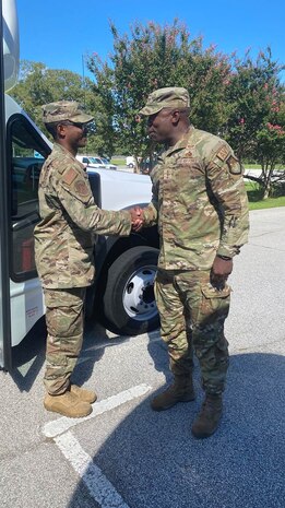 Photo shows two Airmen shaking hands