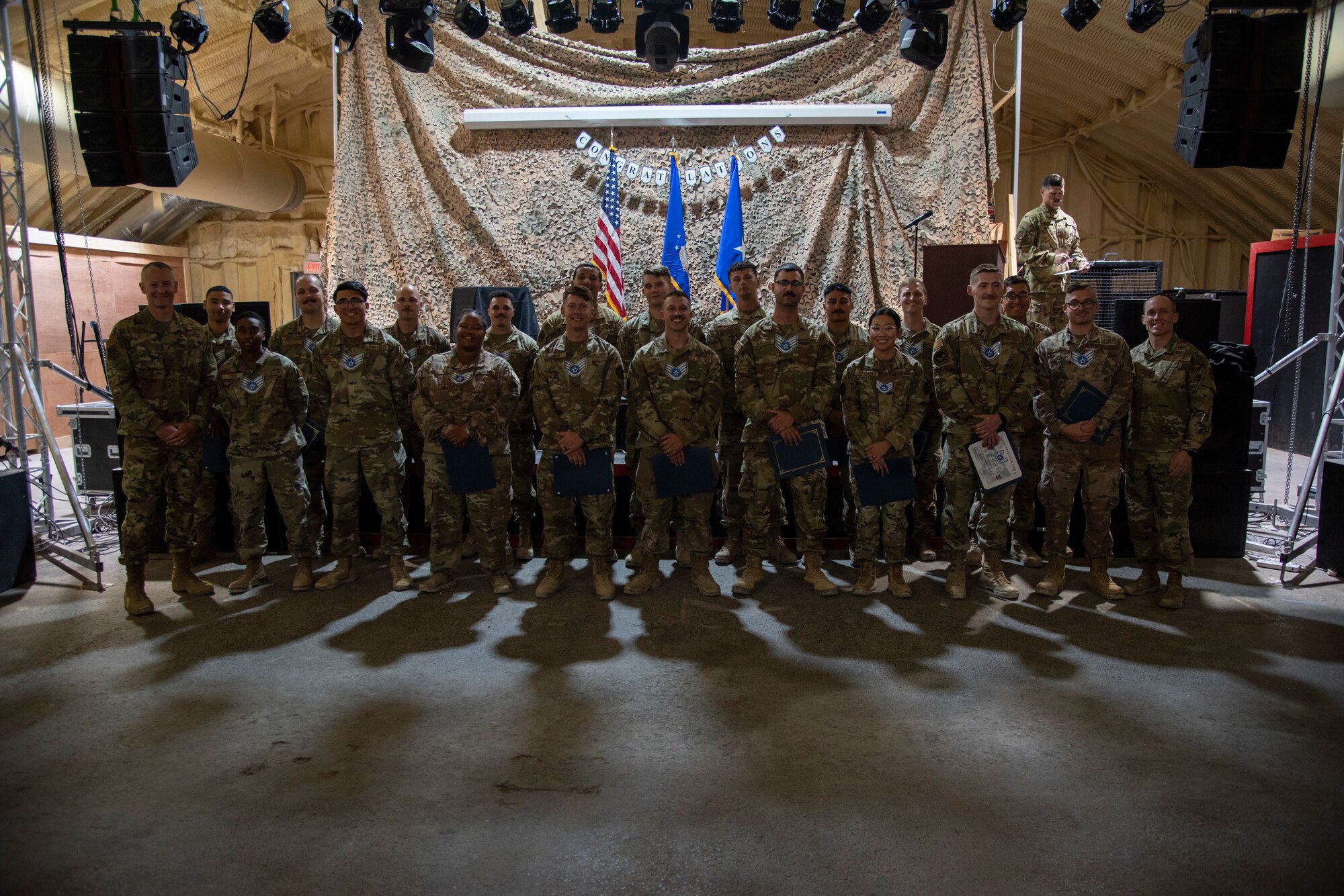 332d Aerial Expeditionary Wing leadership honors the senior airmen who have been selected for promotion to the rank of staff sergeant at an undisclosed location in Southwest Asia, August 30, 2022. (U.S. Air Force photo by: Tech. Sgt. Jim Bentley)