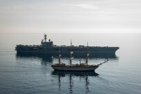 The Nimitz-class aircraft carrier USS George H.W. Bush (CVN 77), transits the Adriatic Sea alongside the Italian training ship ITS Amerigo Vespucci, Sep. 1, 2022.