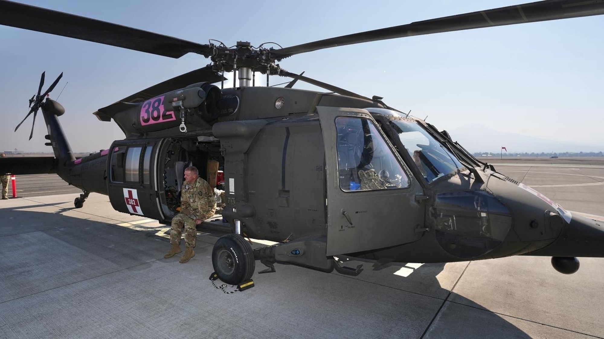Sgt. 1st Class Mark Carter sits in his HH-60 Medevac Black Hawk helicopter on standby for a mission at Medford Airport, Ore., Sept. 2, 2022. Oregon National Guard members were supporting firefighting efforts at the Rum Creek wildfire.