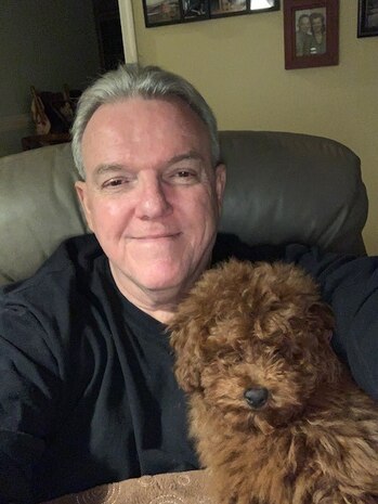 Paquette with his poodle, Rusty.]