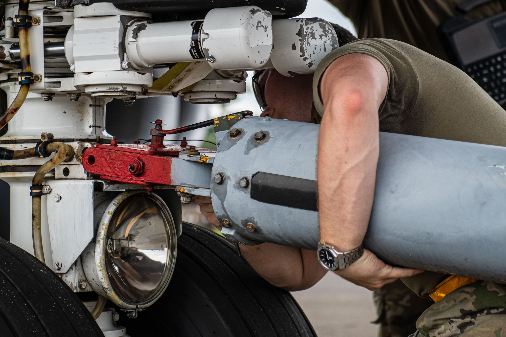 U.S. Air Force Airman 1st Class Blayne Delp, 6th Maintenance Squadron aircraft propulsion apprentice from MacDill Air Force Base, Florida, ensures a tow bar is properly placed on the axle of a KC-135 Stratotanker during the 6th Air Refueling Wing’s Agile Combat Employment capstone exercise at Joint Base Charleston, South Carolina, Aug. 25, 2022. One aspect of the training experience simulated a KC-135 aircraft flying 24/7, landing only to refuel and to be inspected for visual damage. (U.S. Air Force photo by Airman 1st Class Christian Silvera)