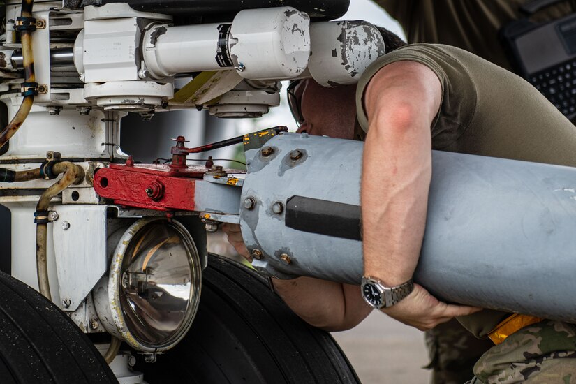 U.S. Air Force Airman 1st Class Blayne Delp, 6th Maintenance Squadron aircraft propulsion apprentice from MacDill Air Force Base, Florida, ensures a tow bar is properly placed on the axle of a KC-135 Stratotanker during the 6th Air Refueling Wing’s Agile Combat Employment capstone exercise at Joint Base Charleston, South Carolina, Aug. 25, 2022. One aspect of the training experience simulated a KC-135 aircraft flying 24/7, landing only to refuel and to be inspected for visual damage. (U.S. Air Force photo by Airman 1st Class Christian Silvera)