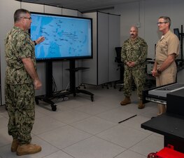 NEWPORT, R.I. (Aug. 31, 2022) Capt. Brian Mutty, commander, Surface Warfare Schools Command (SWSC), left, and Lt. Cmdr. Bobby Knapp, N72 academic director, back right, give Rear Adm. Pete Garvin, commander, Naval Education and Training Command, a brief on the Conning Officer Virtual Environment simulator on Naval Station (NAVSTA) Newport, Aug. 31, 2022. Garvin visited NAVSTA Newport Aug. 31-Sept. 1 to speak with the staff and students of Center for Service Support, SWSC, Senior Enlisted Academy, Officer Training Command Newport, Naval Chaplaincy School, Naval Leadership and Ethics Center, and Navy Supply Corps School. (U.S. Navy photo by Mass Communication Specialist 2nd Class Derien C. Luce)
