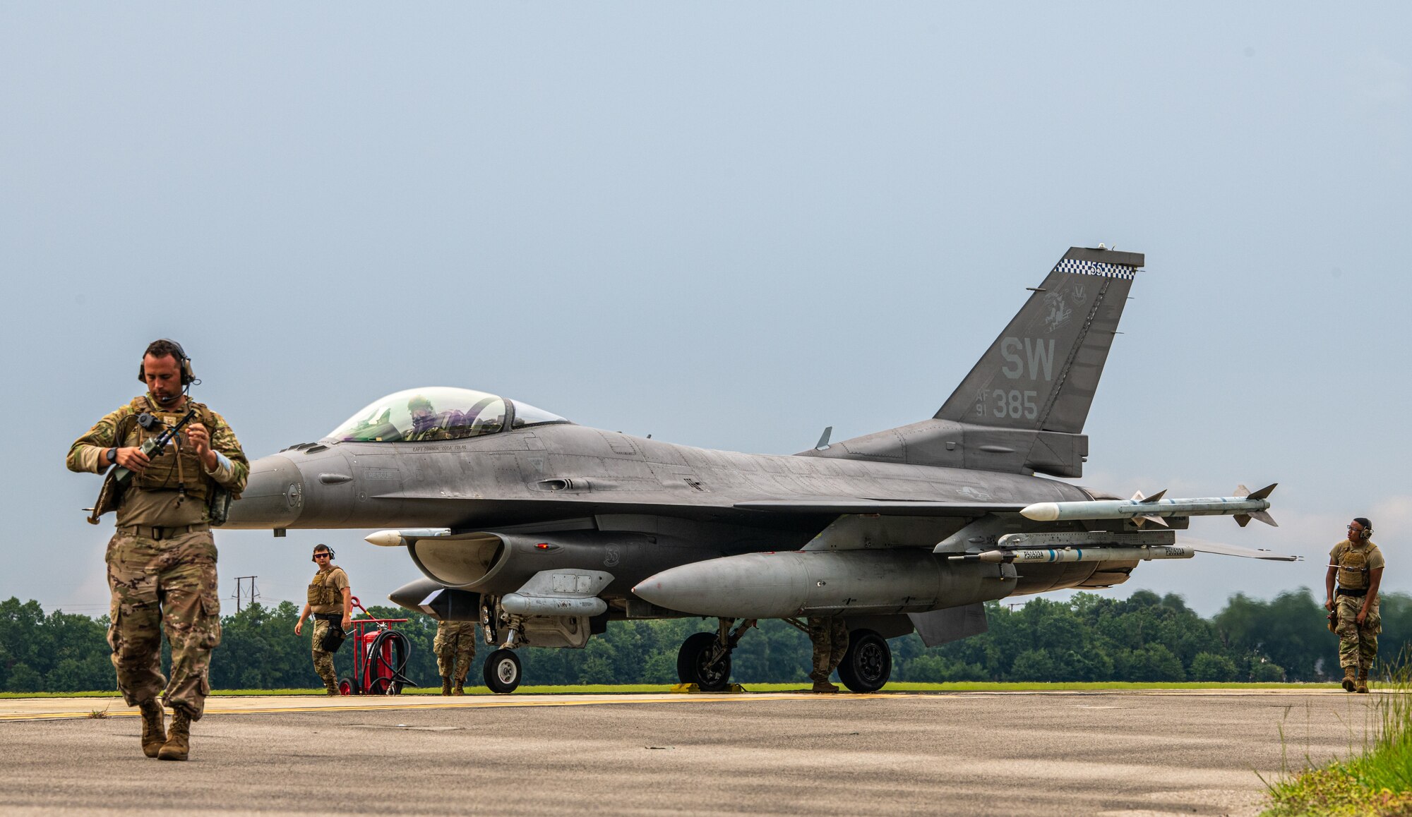 Airmen prepare a F-16 for work