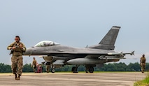 Airmen prepare a F-16 for work