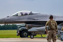 An Airman looks on at a F-16