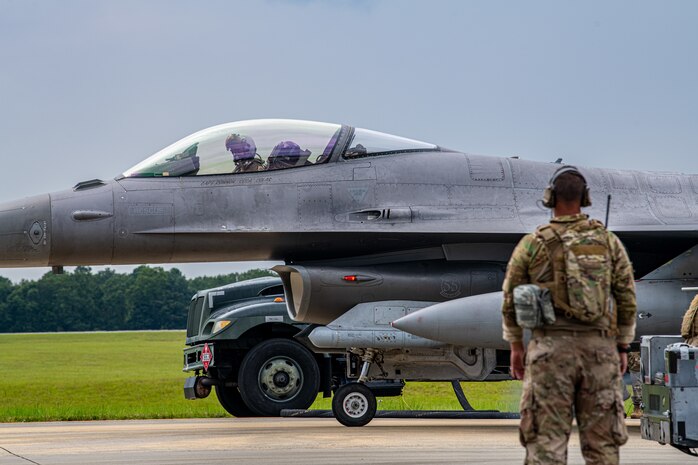 An Airman looks on at a F-16