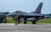 An Airmen directs an F-16