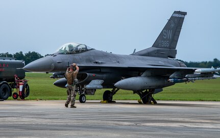 An Airmen directs an F-16