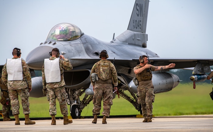 Airmen work on an F-16